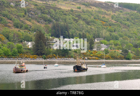 ULLAPOOL, SCOTLAND - 1 MAY 2019: A mix of fishing boats and pleasure craft lie at anchor in Loch Broom, Scotland. Stock Photo