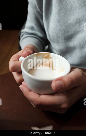 Woman with cappuccino in hands-close-up Stock Photo