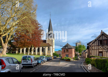 The Église Saint-André by a park in Le Bec-Hellouin, Normandy, France on a sunny spring day Stock Photo
