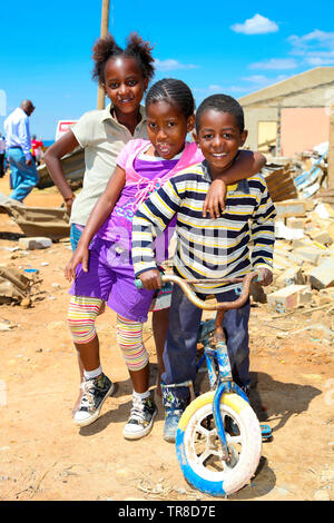 Johannesburg, South Africa - October 04 2011: African Children in a Tornado damaged Township Stock Photo