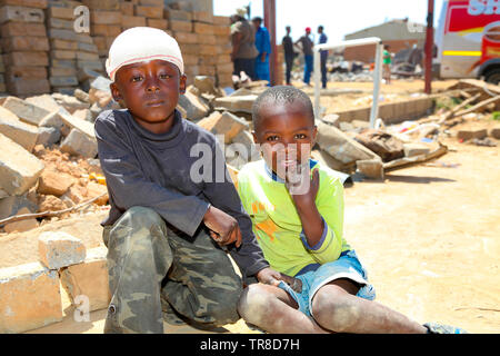 Johannesburg, South Africa - October 04 2011: African Children in a Tornado damaged Township Stock Photo