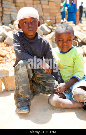 Johannesburg, South Africa - October 04 2011: African Children in a Tornado damaged Township Stock Photo