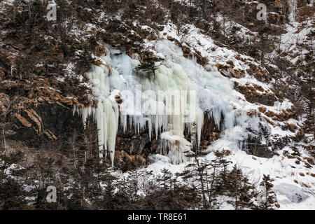 Icicles from seeps and streams along the fjord containing the outport of Grey River, Newfoundland, Canada Stock Photo