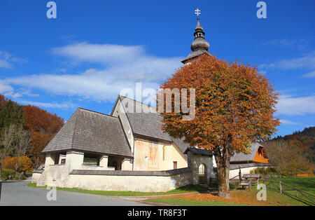 Gothic church of Saint John at Bohinj lake in colours of autumn, Ribcev laz, Juliana Walking trail, Triglav National Park, Slovenia, Central Europe Stock Photo