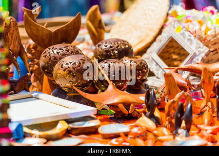 Carved wooden souvenirs in the local market, Rarotonga, Aitutaki, Cook Islands. With selective focus Stock Photo