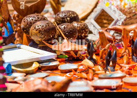 Carved wooden souvenirs in the local market, Rarotonga, Aitutaki, Cook Islands. With selective focus Stock Photo