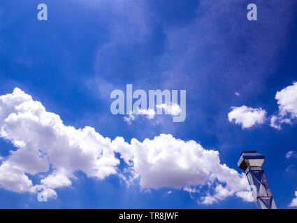 Shiny steel smokestack and cloud in blue sky Stock Photo