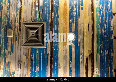 Air conditioner mask, lighting and modern equipment On the ceiling that decorated with old wooden panels and peeling paint Stock Photo