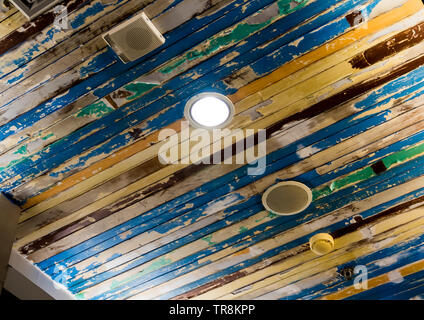 Air conditioner mask, lighting and modern equipment On the ceiling that decorated with old wooden panels and peeling paint Stock Photo