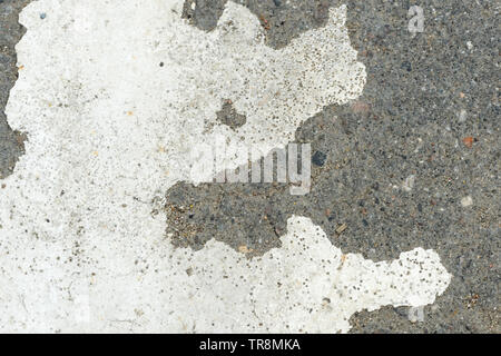 White paint on the old asphalt closeup. Abstract background Stock Photo