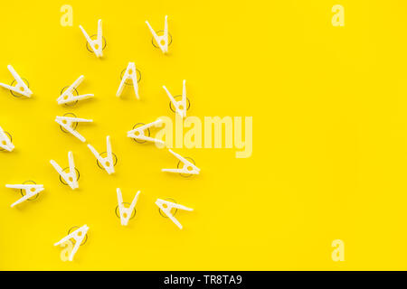 clothespins on yellow color background,copy space Stock Photo