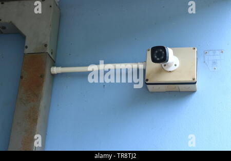 Closeup of cctv camera fixed to the wall of a building, safety concept Stock Photo