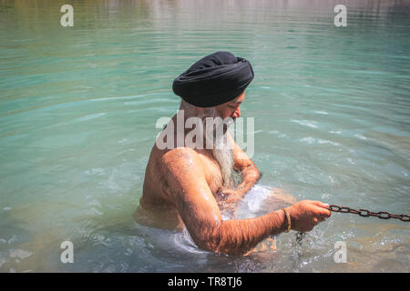 Amritsar, Punjab, India: Dated- 2-04-2019- A Sikh taking a ritual bath in the holy water Stock Photo