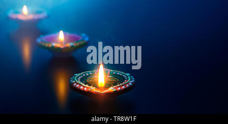 Happy Diwali - Diya oil lamps lit during celebration Stock Photo