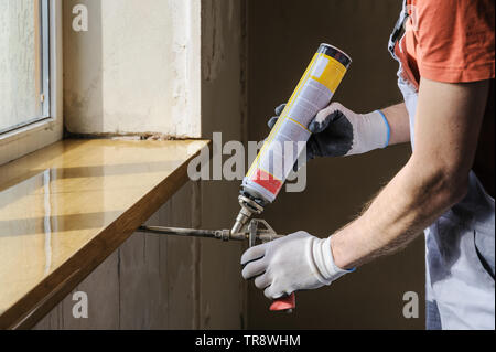 Worker is using a polyurethane foam for installation of window sill Stock  Photo - Alamy