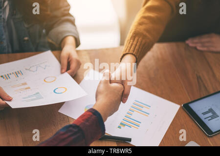 Closeup image of two businessman shaking hands in a meeting Stock Photo