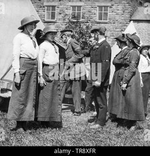 Vintage black and white photograph of members of the British Women's Defence Relief Corps during The First World War. Their camp is being inspected by a British male Officer. Stock Photo