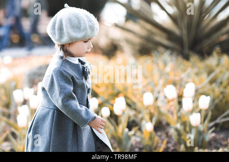 Stylish baby girl 1 2 year old wearing warm jacket outdoors in