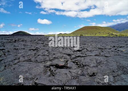 Amazing lava fields in between Mauna Kea and Mauna Loa volcanoes on the big island of Hawaii, devoid of life except some rare instances Stock Photo