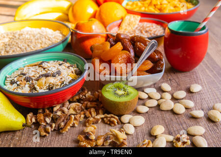 Breakfast served with milk, dried plums and dates on a rustic wooden table Stock Photo
