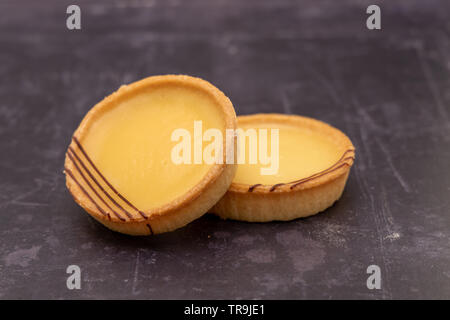 Two lemon tarts on a slate background - shallow depth of field Stock Photo