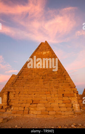 meroitic pyramid in the typical Nubian style at Jebel Barkal in the town of Karima, Sudan. Cloud formations above the pyramid looks like it is on fire Stock Photo