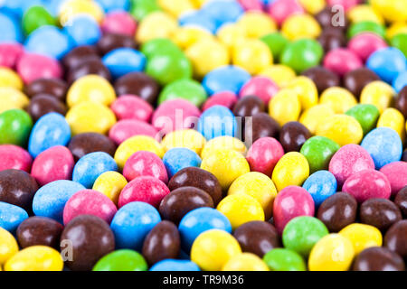 Pile of delicious ainbow colorful chocolate candies background. Macro image. Stock Photo