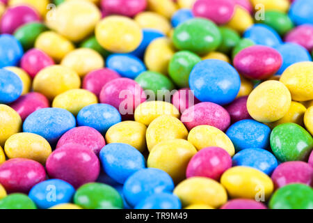 Pile of delicious ainbow colorful chocolate candies background. Macro image. Stock Photo