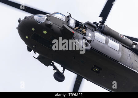 Sikorsky UH-60 Black Hawk transport helicopter flying as part of the support for US President Donald Trump State Visit to the UK. Crewman observing Stock Photo