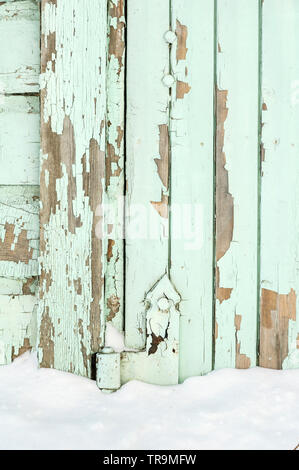 Old painted wall with peeling paint cracked surface Stock Photo