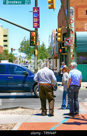 People waiting at the crosswalk on the corner of 6th and Broadway in downtown Tucson AZ Stock Photo