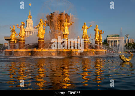 Fountain 'Friendship of peoples' after the restoration and the facade of pavilion №1 'Central' (House of peoples of the USSR) at VDNH in Moscow, Russi Stock Photo