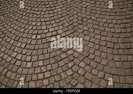 Close-up of stone sidewalk on a sunny day in the City Center at Bruges. Charming town with canals and old buildings in Belgium. Stock Photo