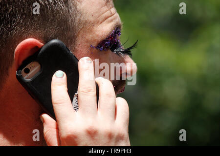 Philadelphia, PA, USA - May 31, 2019: A male in drag talks on his mobile phone. Stock Photo