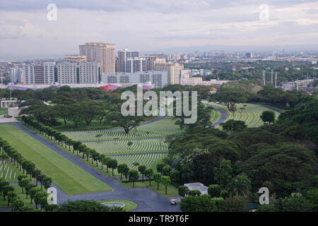 A view of the Manila America Cemetery and Memorial  and further off the city of Pasig across the river from a Bonifacio Global City condominium. Stock Photo