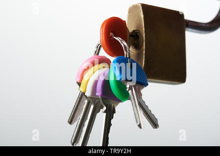Close-up of key inserted in lock hole isolated on white background Stock Photo