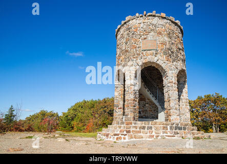 Observation tower at the peak of Mount Battie in Camden, Maine, USA. Sunny, autumn day with bright blue sky background. Stock Photo