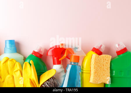 Colorful cleaning set for different surfaces in kitchen, bathroom, other rooms. Copy space for text or logo on pink background. Cleaning service conce Stock Photo