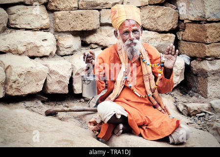 Indian Sadhu in the desert city of Jaisalmer begging for alms. A Sadhu is an Indian holy man of the Hindu faith who has discarded all material wealth Stock Photo