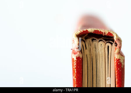 Isolated image of a worn black and red hardcover journal Stock Photo