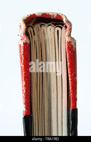 Isolated image of a worn black and red hardcover journal Stock Photo
