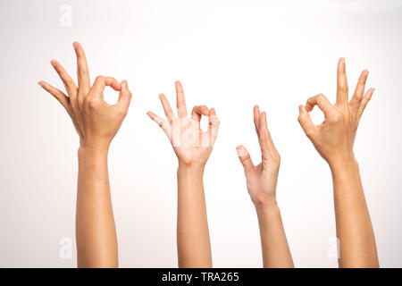 women hand OK sign and raise hand up gesturing on white background in four action Stock Photo