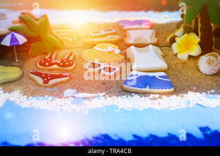 Summer concept of sandy beach, bikini, straw hat, shells and  sunset Stock Photo