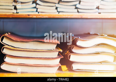 book stack on a wooden shelf, colorful leather cover book Stock Photo