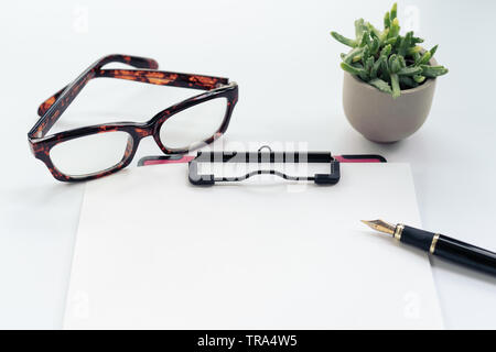 Business objects, clipboard with blank sheet of paper, pen, glasses on white background Stock Photo