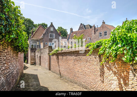 Middelburg, The Netherlands, May 30, 2019: alley in the old town lined with brick walls that close off private gardens Stock Photo
