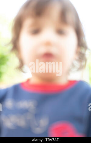 Blurred abstract portrait of child for background - Blur abstract image of boy girl for backdrop - Vertical blurred portrait abstract Stock Photo