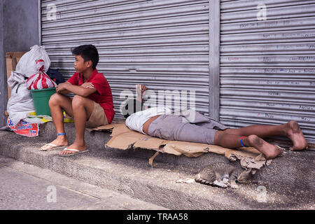 Manila, Philippines - December 21, 2016: Homeless filipino boys on the streets Stock Photo