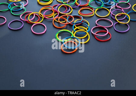 Teamwork concept. group of colorful rubber band on black background with copy space Stock Photo