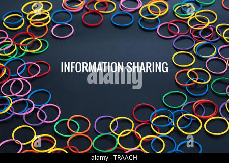 Information sharing concept, colorful rubber band with word Information Sharing on black background Stock Photo